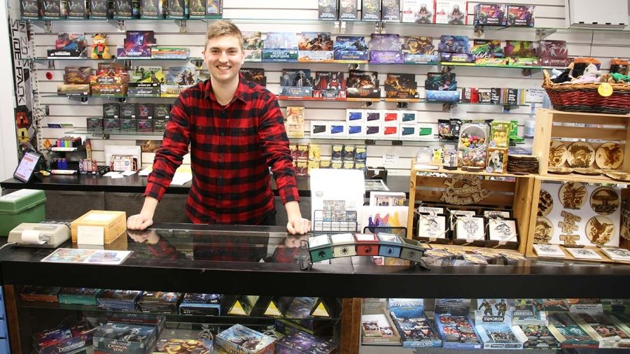 Business Adminstration Program student Brady Stocks in his shop with trading cards