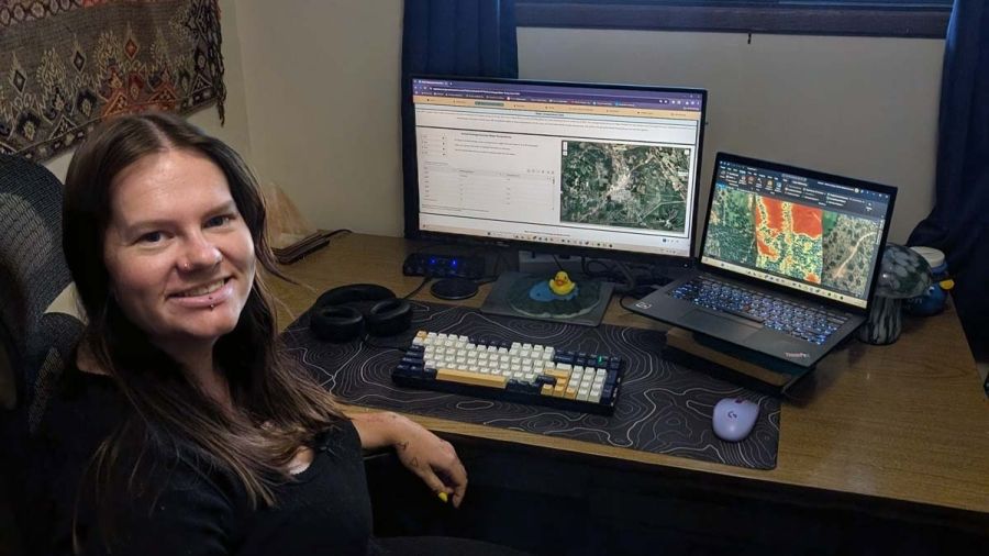 Intern Hannah Murphy sits at a desk in front of a computer 