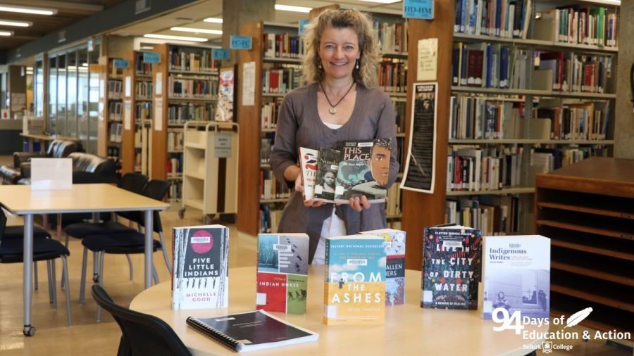 An image of Jennie Barron in the library surrounded by books