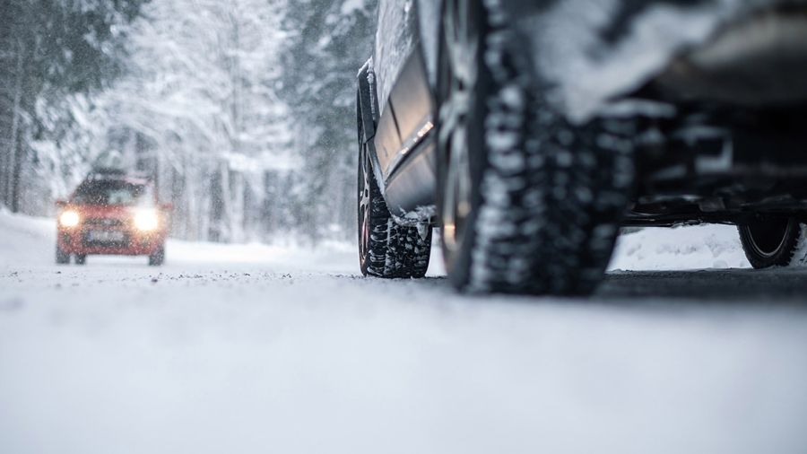 A close-up of a car driving on a snowy road