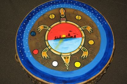 An image of drum with a turtle painted on the drum skin