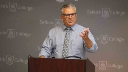 Selkirk College Foundation chair Bruce LaRose stands at a podium