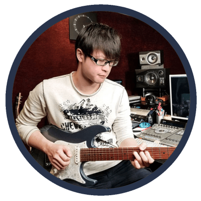 An image of graduate Kit Tang playing guitar