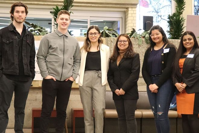 Winners of the in-person Business Plan Tradeshow Competition standing proud after hearing the results.