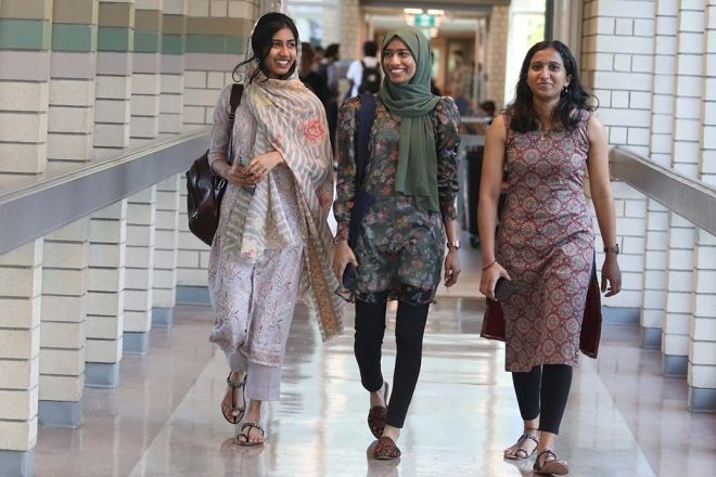 Three international students walking down hallway on the Castlegar Campus
