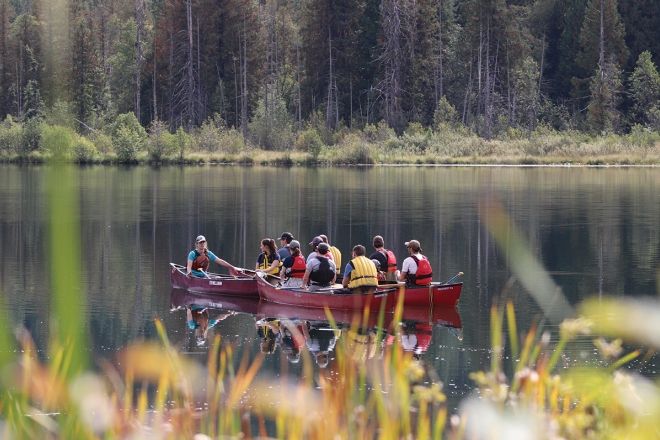 Students canoe on a lake