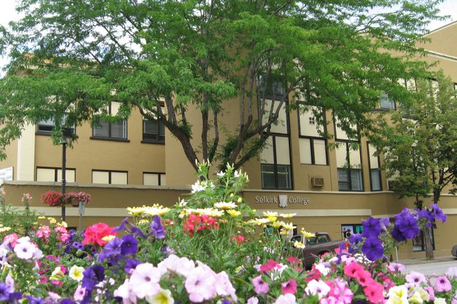 Selkirk College's Trail Campus building with pink and purple flowers